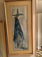 Frontal view of the framed print showing the full artwork featuring the abstract figure in a tall hat and cloak.