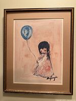 Full view of the framed DeGrazia print titled 'Girl with Balloon' depicting a young girl holding a blue balloon against a pink background.