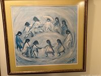 Front view of large framed print showing circular composition of children holding hands.