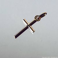 Front view of the gold cross pendant showing cylindrical arms and bail