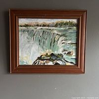 Frontal image of the original oil painting of Niagara Falls featuring vibrant cascading water and rocky foreground, set in a wooden frame.