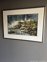 Frontal view of the framed watercolour painting 'Salt Water Tiers' showing lighthouse, rocky coastline, and ocean waves.