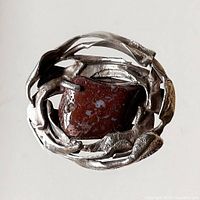 Front view of the vintage sterling silver modernist brooch with brown stone centerpiece, showing organic textured silver design.