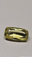Close-up photo of the long cushion cut lemon citrine gemstone showing the rectangular faceted shape and bright lemon yellow color.