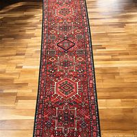 Full-length view of red geometric runner on hardwood floor