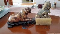Panther and lion figurines on wooden table showing size and detail