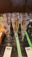 Photo showing all six wine glasses arranged in two rows, displaying the gold leaf designs and frosted glass.