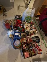 Overall assortment of boxes and bag with mixed Christmas décor items on floor