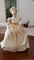 Front view of Royal Staffordshire porcelain figurine Eugenie showing detailed facial features and peach gown