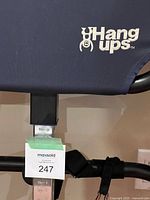 Close-up of the blue backrest with Hang Ups logo and height adjustment bar with MaxSold lot tag.