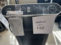 Top control panel with push-button modes labeled Silent, Germ, Allergy, Max; dimmer, filter clean indicator, reset button and on/off; remote taped at side; MaxSold tag.