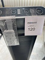 Top view of the control panel and remote control taped to the unit showing mode buttons and indicators.