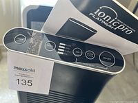 Top view of Ionic Pro Platinum air purifier control panel showing button labels and modes: Silent, Germ, Allergy, Max, Filter Clean, Timer, Dim, On/Off.