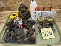 Tray with antique oil lamps, brass drawer pulls, metal pulleys, hinges, glue bottle and miscellaneous metal hardware.