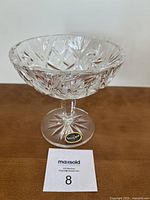 Full view of vintage crystal pedestal dish with finely engraved pinwheel and Star of David in center, showing thick crystal stem and round base.