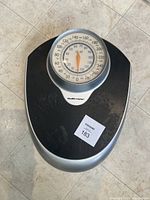Full top view of the black platform bathroom scale with large circular dial and Health o meter branding.