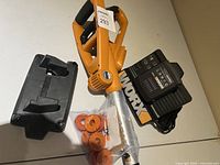 Ryobi hedge trimmer with Worx battery charger and orange replacement parts