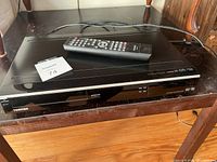 Full top and front view showing Toshiba DVD recorder with remote on top.