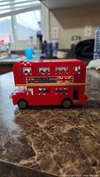 Side view of the red Lego double decker bus showing British flag decal and windows.