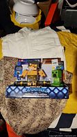 Front view of Minecraft Legends Creeper vs Piglin Bruiser toy set in original sealed packaging showing both figures