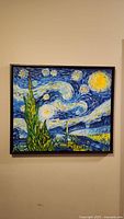 Framed Van Gogh Starry Night painting on wall