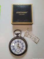 Antique 15 jewels 800 silver car clock with original box and handwritten tag showing condition and details.
