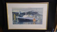 Framed art print showing Holland America ship Rotterdam docked at a city with mountains behind, clear glass with reflections