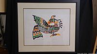 Framed John Nelson indigenous art print titled "Thunderbird" showing full framed piece with black frame and white matte.