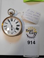 Watch face with enamel dial, Roman numerals, subsidiary seconds and seller's handwritten tag