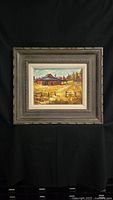 Full view of framed oil painting on board depicting a red house, yellow field, and trees.