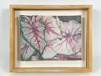 Framed artwork showing the full piece with light maple frame and white mat surrounding the cotton print.