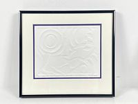 Framed embossed print showing the full artwork with white mat and purple inner border in black frame.