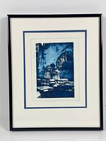 Framed photolithograph artwork displayed, showing full view within black frame with double white mats and a blue inset mat.