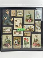 Full view of framed lot showing all thirteen die cut cards and illustrations arranged in a grid