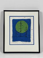 Framed lithograph with blue and green artwork depicting three trees in front of a circular shape.