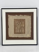 Full view of the professionally framed etching with black frame, double matte in brown and beige, clear glass, showing the artwork centered.