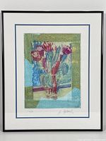 Framed lithograph artwork showing tulips in a vase with signature and edition number visible at bottom.