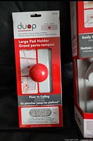 Photo of new unopened package of Duop large pad holder with red quickball attachment visible through window