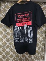 Back of the black Bon Jovi tour T-shirt showing band image and tour cities/dates graphic in red and white print.