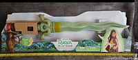 Photo of the unopened Disney Raya the Last Dragon light-up sword toy in packaging showing front view with green LED lights visible.