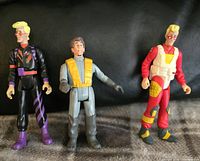 Three Kenner The Real Ghostbusters action figures posed standing on a flat surface with black background