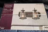 Box of the Home Decorators Collection Georgina 2-Light Vanity Fixture showing product branding and image on front