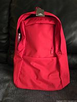 Front view of new Adidas deep bright pink backpack showing front zipper pocket and large main compartment.