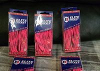 Four boxed pairs of Elite Hockey ProLace waxed molded hockey skate laces, each 84 inches long, bright pink with black dotted pattern, labeled official gear.