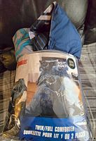 Photo of Marvel Black Panther comforter set in original packaging showing cover with Black Panther artwork and twin/full size label.