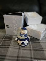 Photo of the Toronto Maple Leafs snow globe in front of its box and packing foam.