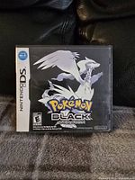 Front cover of the Nintendo DS Pokémon Black Version game case showing artwork of Reshiram with Nintendo and game branding.