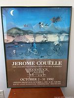 Front view of framed surrealist art poster featuring fish on bicycles under a moonlit sky