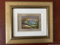 Frontal image showing the miniature framed oil painting with landscape scene.