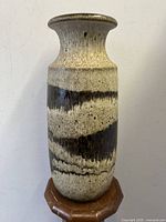 Full body view of tall Scheurich fat lava vase showing brown and beige crater glaze pattern and flared top.